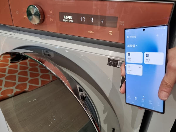 스마트폰 스마트싱스를 이용해 세탁기를 컨트롤하는 모습. [사진=녹색경제신문]